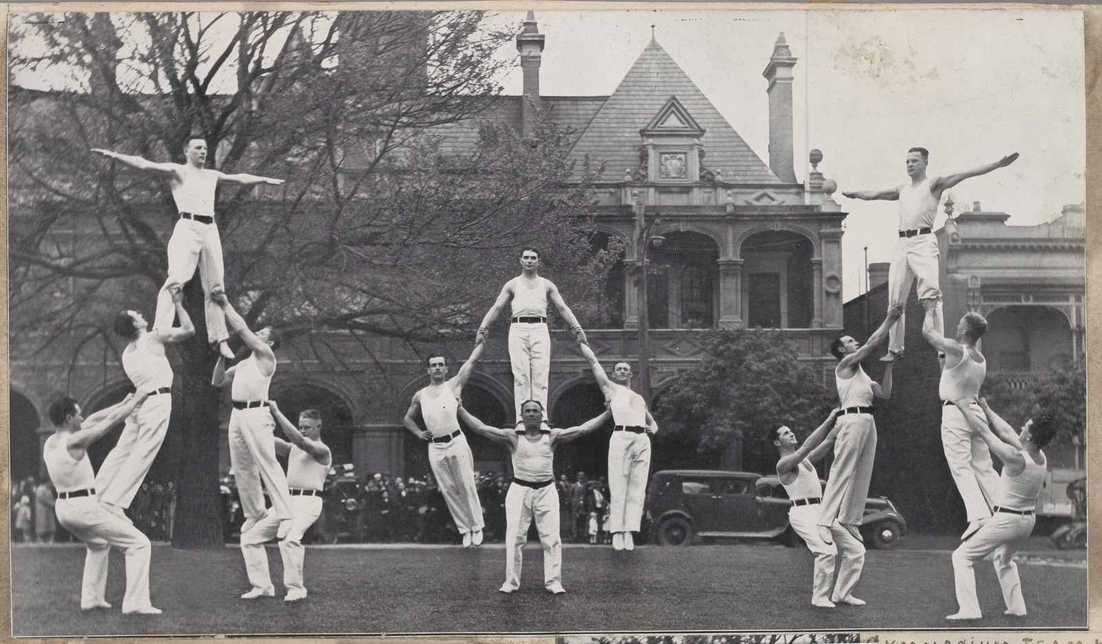 Three groups of firefighters in acrobatic poses, several held aloft