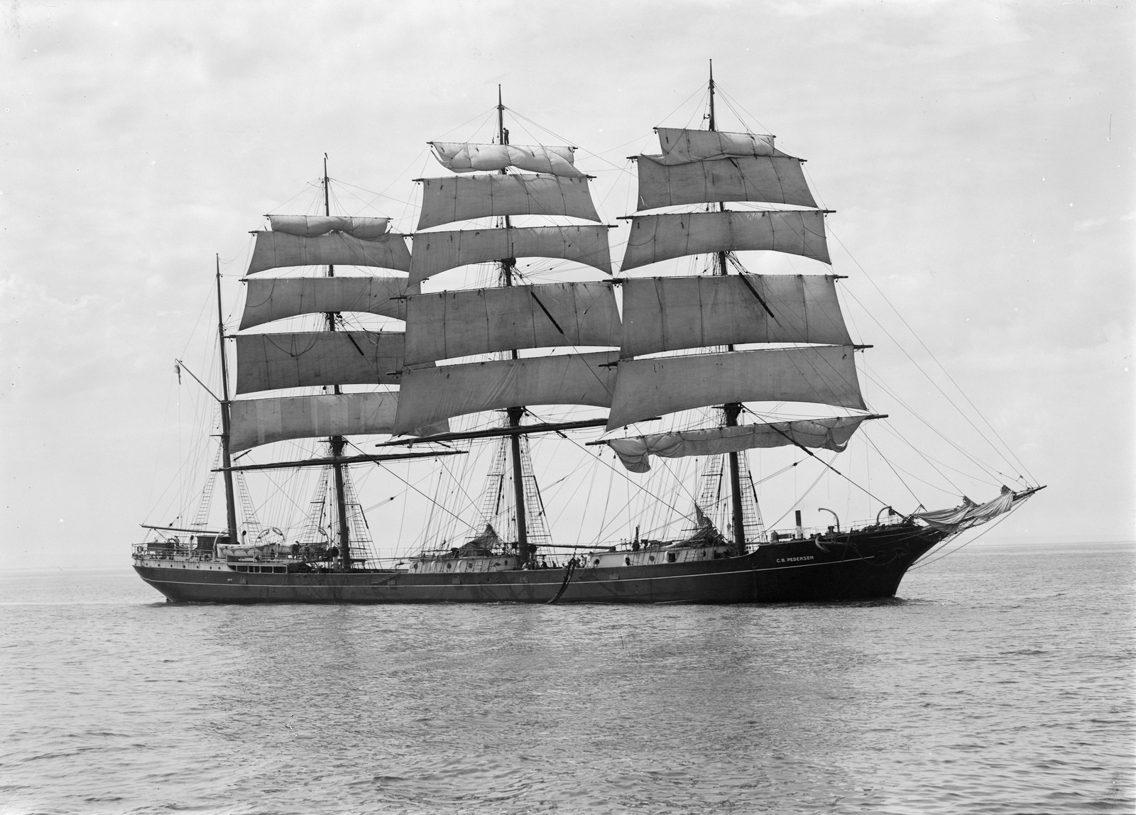 Black and white photograph of three-masted sailing ship under full sail