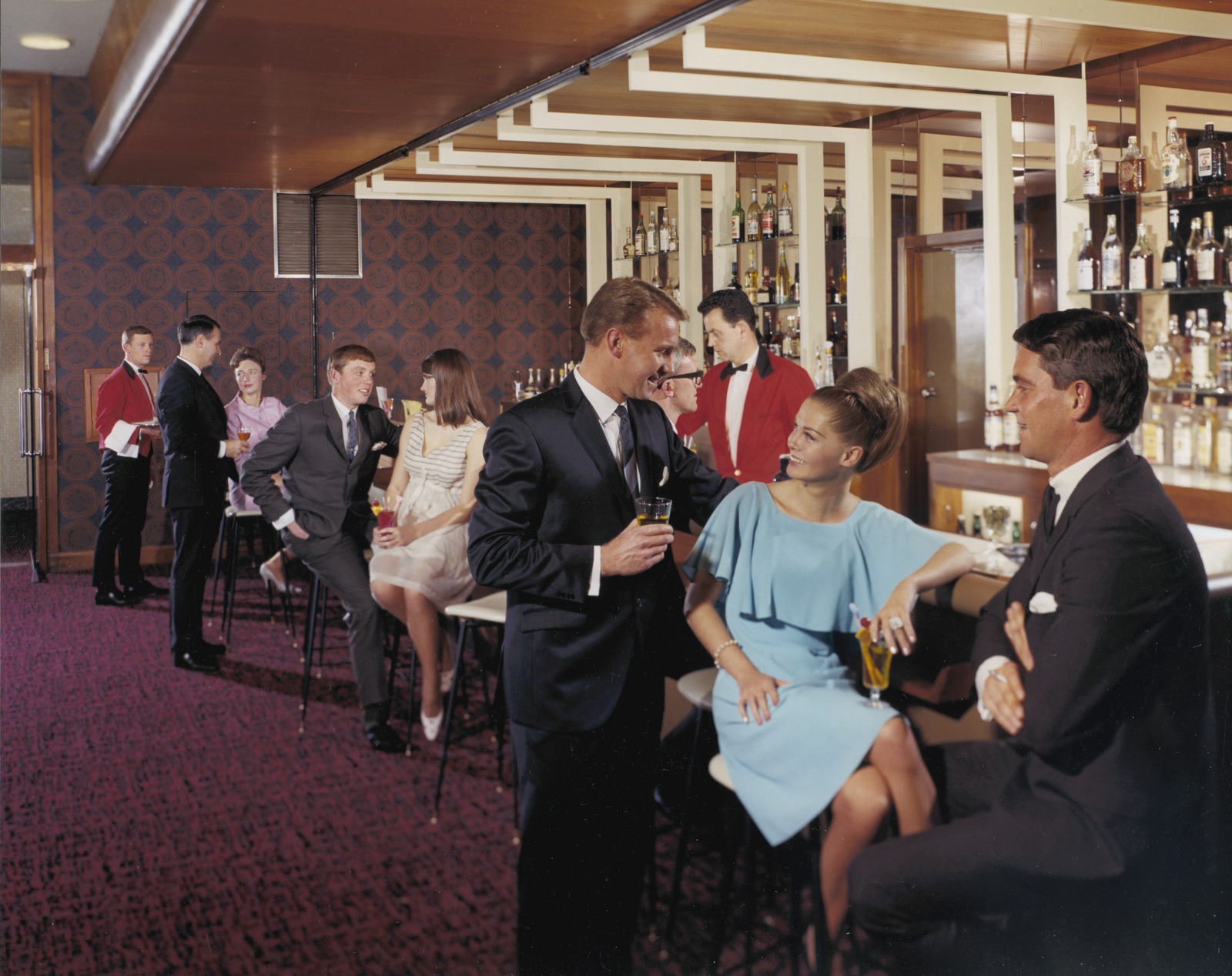 People and waiters at a bar in a hotel