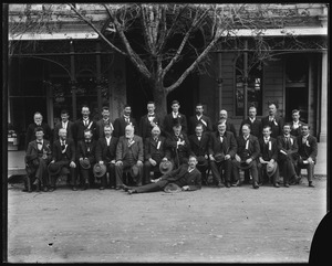 Group portrait of men assembled in front of Victoria Hall