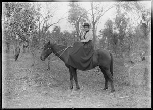 Portrait of woman seated side-saddle on horse