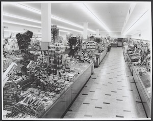 Interior of Coles store in Mackay showing counters with merchandise including Colgate toothpaste for 2/9d Store No. 214