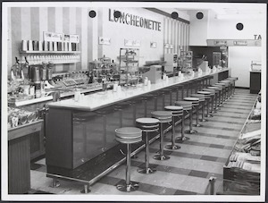 Luncheonette showing stools along bench and food heating equipment in Coles Victoria Park Store No. 195