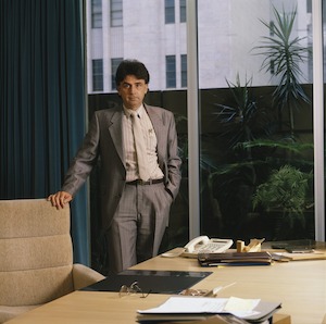 Alan Williams Managing Director standing beside his desk in office Coles New World